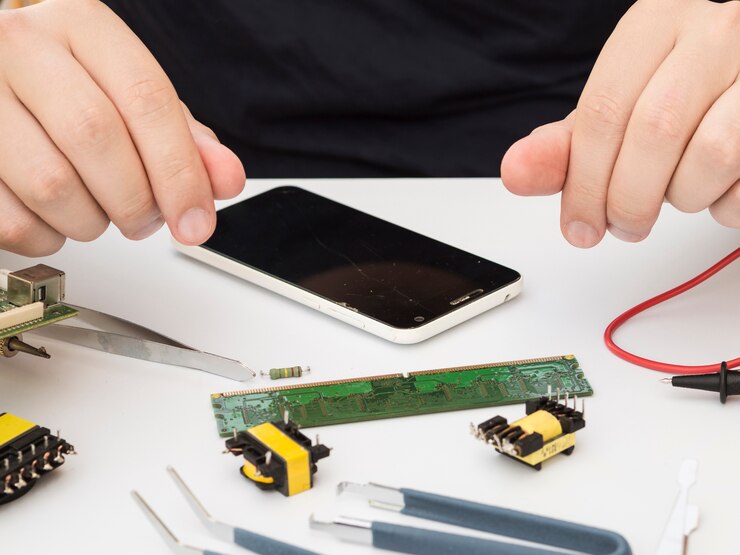 man-sitting-his-work-table-with-electronics_23-2148254089