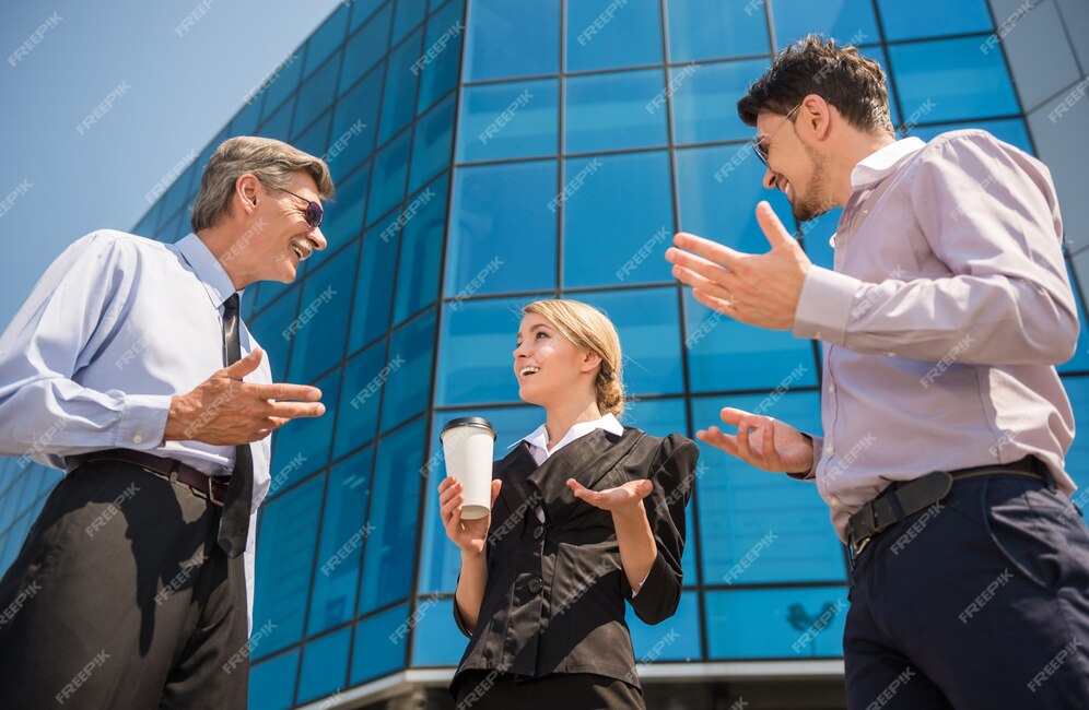 people-discussing-project-while-standing-front-office_85574-4865