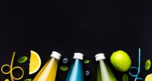 top-view-bottles-with-soft-drinks-fruits_23-2148691258